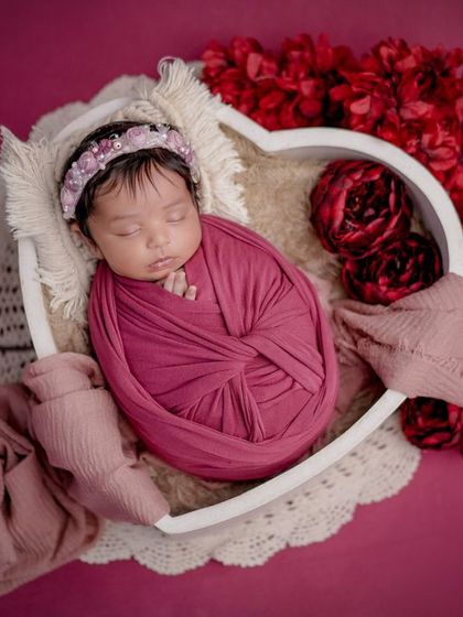 A heart full of love. This baby is swaddled and placed in a heart-shaped bowl, a sweet and symbolic way to capture your love for them.