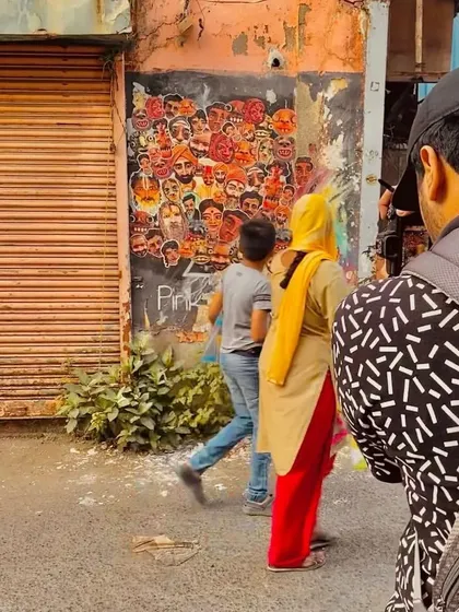 An artist's call to action on Chapel Road, Bandra. This paste-up collage of faces is an invitation for other artists to join in and turn the wall into a collaborative "urban gallery."
