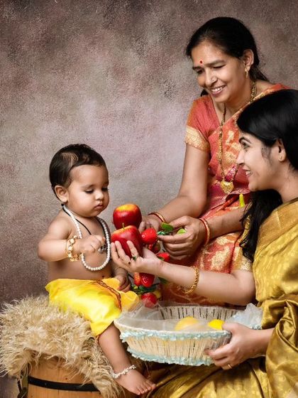 I also offer traditional Indian themes for a classic and culturally rich photoshoot. Here, a baby dressed as little Krishna shares fruits with his mother and grandmother, creating a timeless portrait.