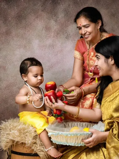 A beautiful fine-art portrait that blends traditional Indian attire with classic painterly lighting. This multi-generational photo has the feel of a timeless painting, celebrating family heritage and connection.