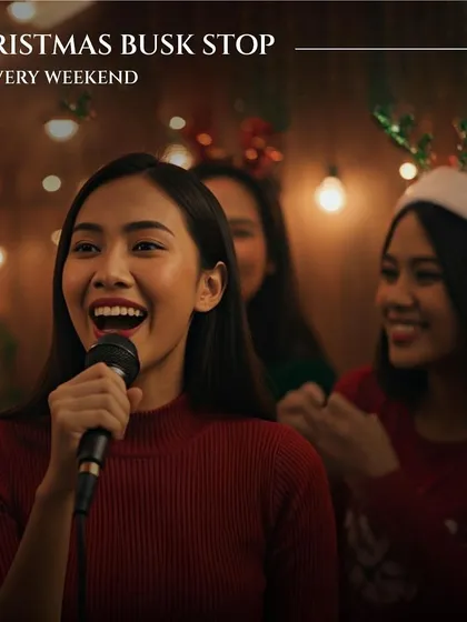 A woman joyfully sings karaoke at our Christmas Busk Stop. This image is part of a series showing the variety of festive activities we offer, from music to markets.