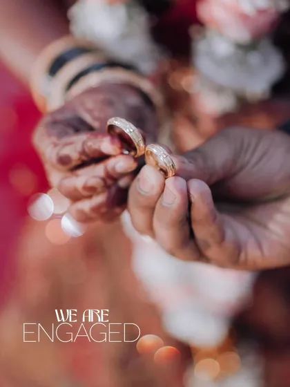 A close-up shot of the couple's hands holding their engagement rings. This artistic photo is a beautiful way to announce that "We Are Engaged."