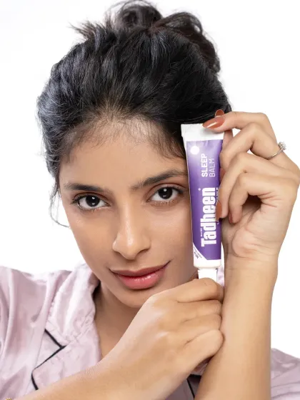 A clean, product-forward shot for a Tadheen beauty campaign. The focus is on the product itself, with the model's direct gaze creating a personal connection and sense of trust.