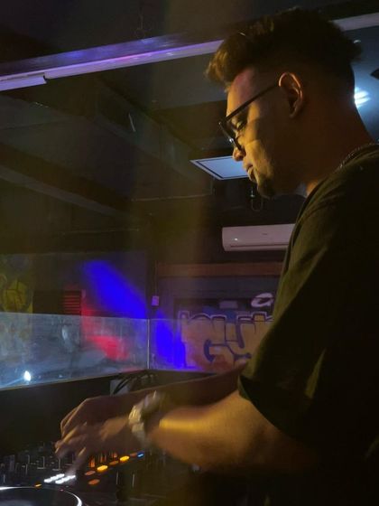 A side profile showing my concentration during a set. I take my craft seriously, which means no cringe tracks, just expertly mixed music.