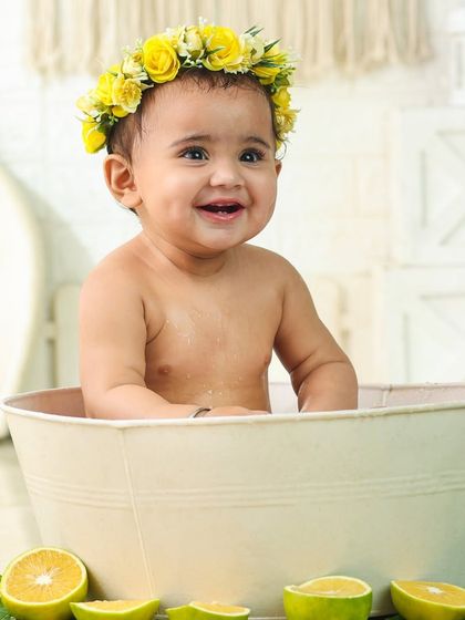 The pure joy of bath time. This little one's happy smile is absolutely infectious in this bright and cheerful milk bath photo.
