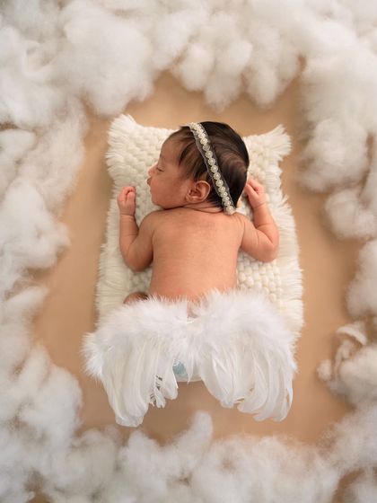 A tiny bit of heaven on earth. This creative overhead shot with angel wings against a neutral background is simple, artistic, and absolutely beautiful.