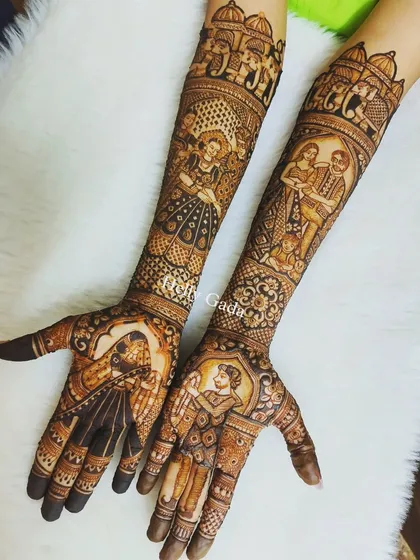 This intricate design features multiple stories, including a dancing bride, the couple together, and portraits on the palms. Elephants and traditional architecture complete this royal look.