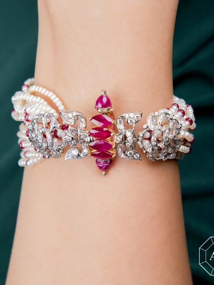 Indulge in the fantasy of eternal elegance with this Ruby, Pearl, and Diamond Bracelet that tells a story of passion and luxury.
