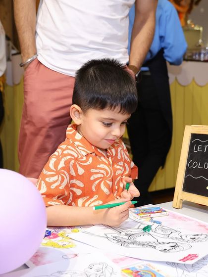 A young guest gets creative at the princess-themed coloring station. We provide all the materials needed for a fun and artistic party activity.