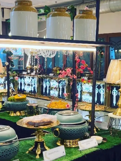 I use unique crockery and display stands to make every dish stand out. This setup with pastel green serveware and gold accents adds a touch of glamour to the buffet.