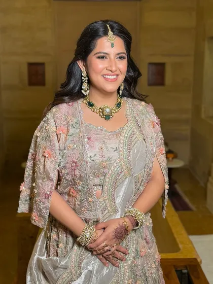 The complete look, showcasing how the soft makeup and hair balance the intricately embroidered outfit.