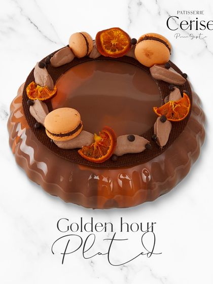 Golden hour, plated. This is my Valencian Sunshine entremet, where golden citrus from Malta oranges meets delicate chocolate, crowned with macarons.