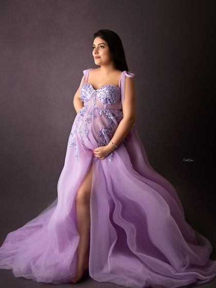 A full-length view of this stunning lavender gown, showing the thigh-high slit and the beautiful way the fabric drapes around her.