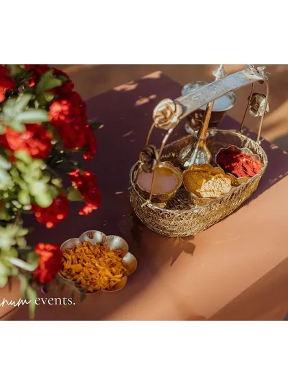 A close-up of the brass basket holding items for the puja, a small but significant detail.