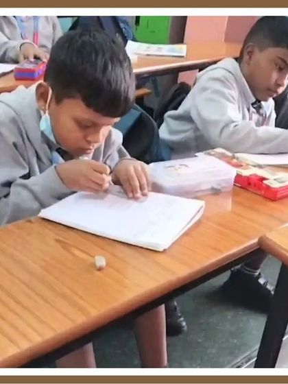 A student is deeply focused on his work, carefully assembling his project at his desk. This image reflects the quiet dedication and concentration that our workshops inspire.