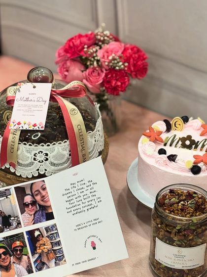 Our Mother's Day menu is all about celebrating mom with love. This spread includes a custom cake, a beautiful cloche cake, and jars of our healthy granola, along with a personalized card.