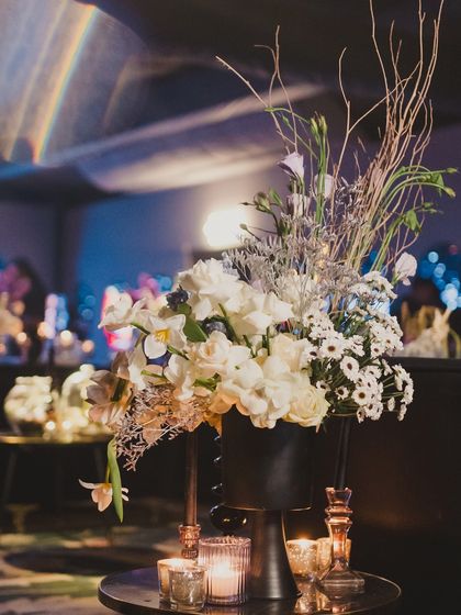 A close-up of the 'deep-space' floral arrangements, which used white flowers and silver-painted branches to create an otherworldly, celestial feel.