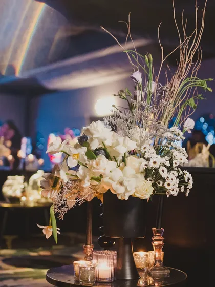 A close-up of the 'deep-space' floral arrangements, which used white flowers and silver-painted branches to create an otherworldly, celestial feel.
