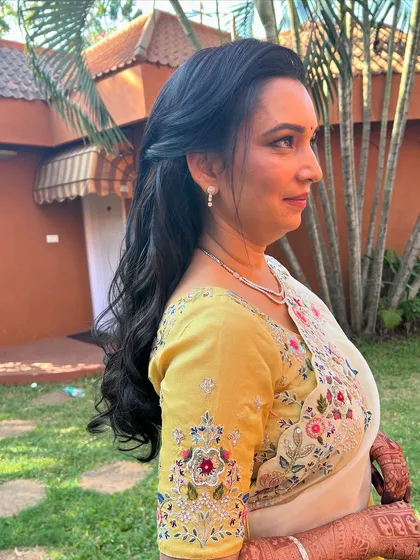 The client looking beautiful and sophisticated with her simple half-updo.
