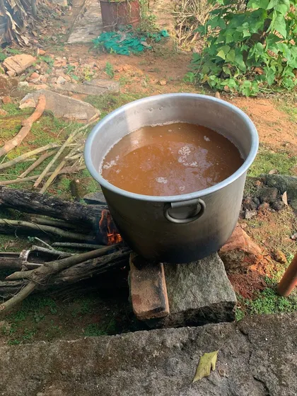 Here you can see our Mudaré Kanni, a traditional Kodava horsegram sauce, being slow-cooked for two days over an open fire. This traditional method gives it a unique silky, smoky flavor.