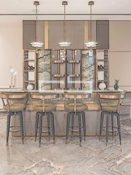 We designed this modern bar area for a client who loves to entertain. A semi-circular marble bar with polished metal accents is complemented by sleek bar stools and warm pendant lights, creating a luxurious and sophisticated ambiance.