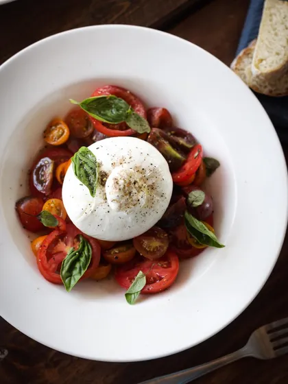 Another angle of the vibrant Burrata salad, a dish that teaches balance in flavor, texture, and color.