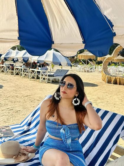 A closer shot of my beach look, showing off my sunglasses and earrings. I always highlight the accessories that complete the outfit.