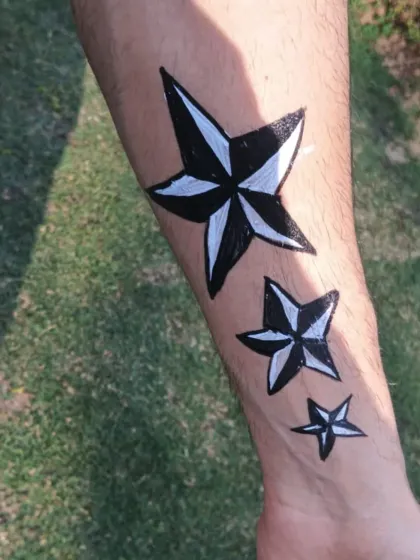 A finished temporary tattoo of nautical stars, showing a clean and bold design that is popular with older kids and adults.