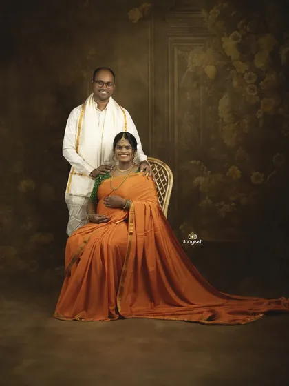 A classic South Indian maternity portrait. The couple is dressed in traditional attire, creating a timeless memory that honors their roots.