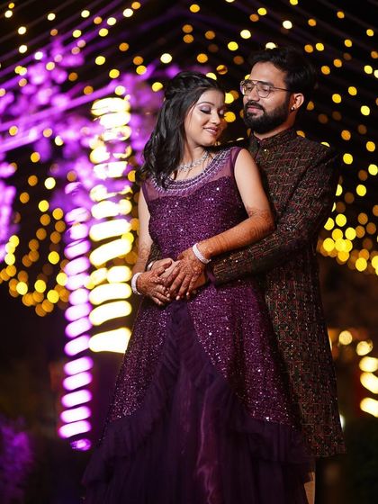 A beautiful shot of the couple under fairy lights. The bride's makeup is designed to look stunning in any lighting, ensuring she glows all night long.