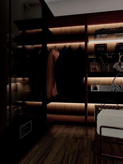 A glimpse into a luxurious walk-in closet design with dark wood and integrated backlighting. This space is designed for organization, with dedicated sections for clothes, bags, and accessories.