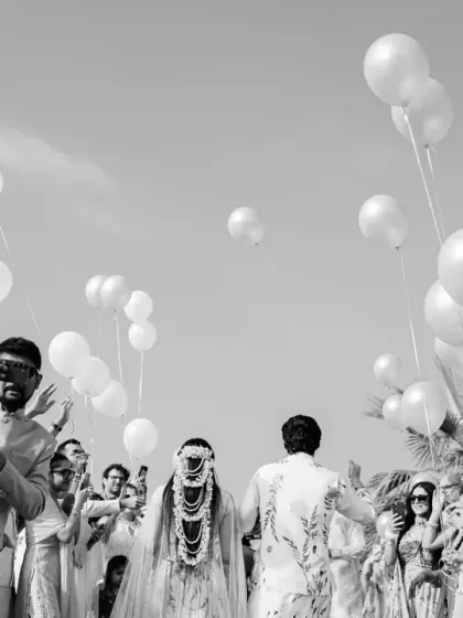 A sky full of balloons creates a dreamy, celebratory path for the couple's Haldi entrance. This black and white shot beautifully captures the scale and joy of the moment.