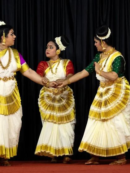 A trio of dancers performing the "Ashtapadi" at Guruvayur, showcasing the beauty of small group formations.