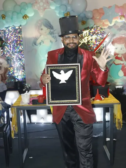 A classic pose with a dove picture frame illusion. This trick, where a picture of a dove comes to life, is a beautiful and artistic part of my show.