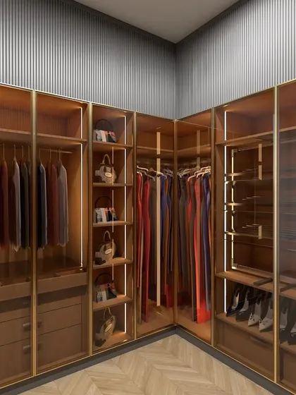 This corner walk-in closet demonstrates my approach to high-end customization. By using glass doors and integrated lighting, I created a space that feels open and luxurious, turning an often-underutilized corner into a stunning feature of the room.