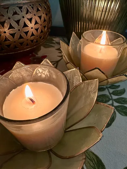 Setting the mood for a relaxing night in. Here are two of my simple votive candles placed in elegant gold lotus holders, creating a cozy and serene atmosphere.