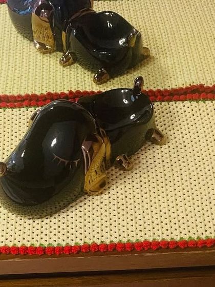 A custom-made side table runner with a red tulip border. This shows how I can create pieces to fit specific furniture dimensions.