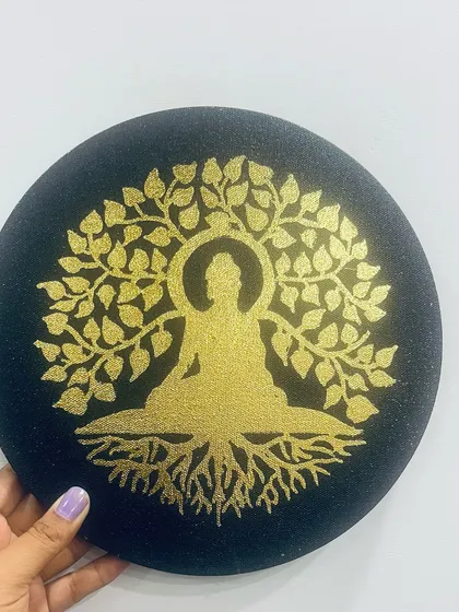 A piece for quiet contemplation. This custom artwork features Buddha meditating under the Bodhi tree, painted with shimmering gold acrylic on a round black canvas. It’s designed to be a focal point of peace and serenity in any room.