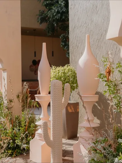 A close-up of the decor elements from the 'Desert Oasis' Haldi, showing the custom-made cacti and elegant vases that contributed to the unique theme.