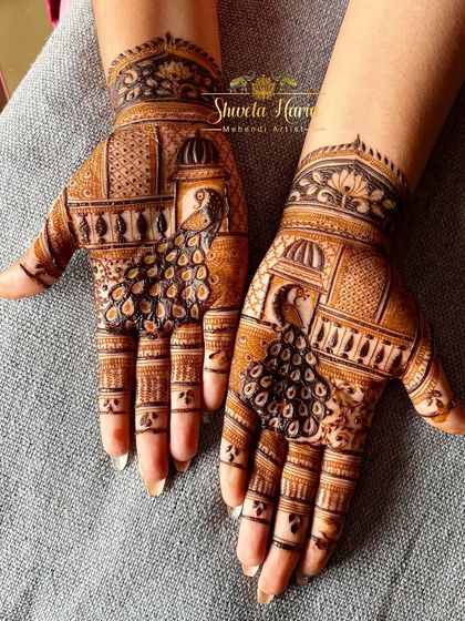 A striking back-hand design with bold peacocks perched in front of palace windows, creating a beautiful architectural theme.