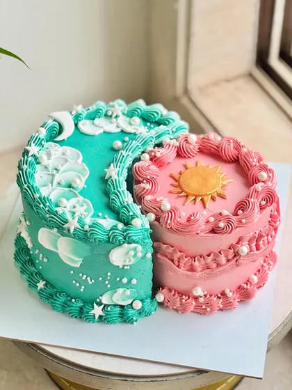 A different angle of the sun and moon cake, showing the intricate piping and the way the two distinct designs complement each other.