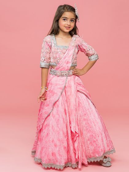 A beautiful tie dye print pink saree, pre draped for ease and comfort, with an embellished blouse.