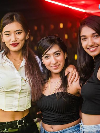 A group of friends smiling for the camera.