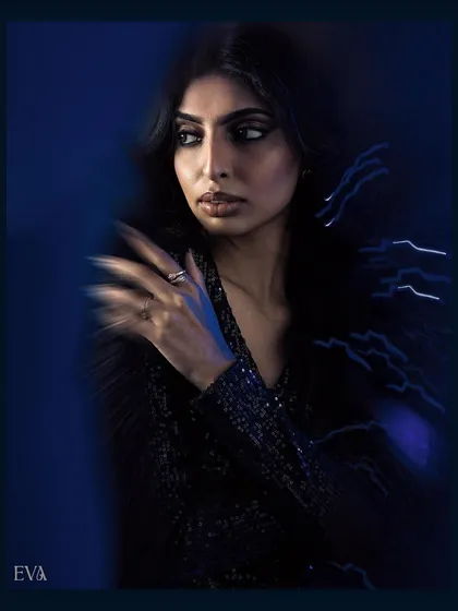 A close-up portrait from our motion blur series. The artistic blur around the model's hand and the dramatic blue lighting create a mysterious and high-fashion mood.