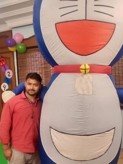 One of my team members posing with a large, inflatable Doraemon character. I have a wide variety of inflatable and costume characters available to fit many popular cartoon themes.