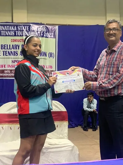 Sahana H Murthy receiving her certificate for being the U17 runner-up at the Bellary State Ranking Tournament.