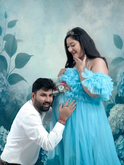 Listening for a heartbeat. This sweet, candid moment is made even more magical with the addition of a painted floral background.
