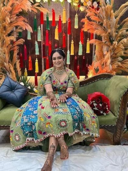 Another shot of the beautiful bride at her ceremony, showcasing her stunning outfit and our complementary mehndi design.