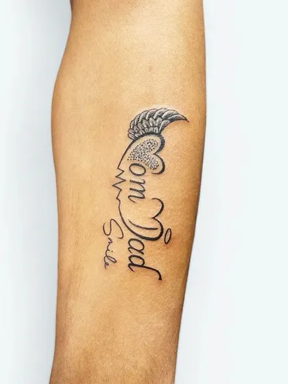 A custom design that combines the names "Mom" and "Dad" with a heartbeat, a smile, and a single wing. It's a unique and personal tribute to parents.
