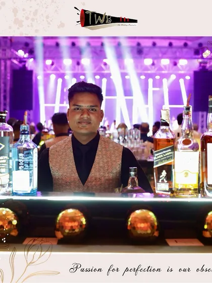 A bartender at his station, surrounded by premium liquors, ready for a busy Sangeet night at The Westin Mumbai.